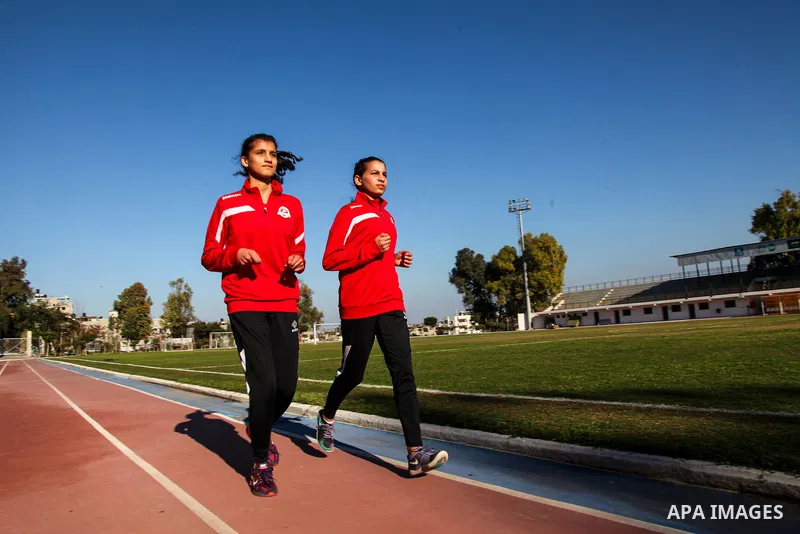 Two Palestinian runners train in a stadium in Gaza City on February 15, 2021. It is assumed that the ancestors of humankind developed the ability to run for long distances about 2.6 million years ago, probably in order t...