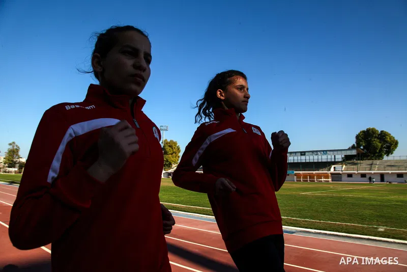 Two Palestinian runners train in a stadium in Gaza City on February 15, 2021. It is assumed that the ancestors of humankind developed the ability to run for long distances about 2.6 million years ago, probably in order t...
