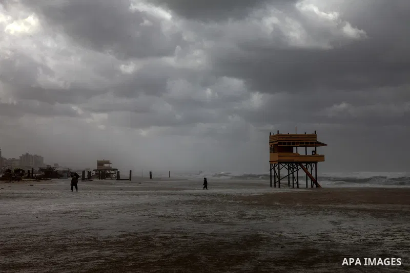 Palestians enjoy during a stormy day, at a beach in Gaza city, on February 17, 2021. The cloudy, stormy and very cold conditions are expected to continue on Thursday. Scattered torrential rain showers with thunderstorms...