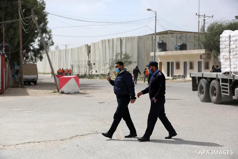 Palestinian health workers unload the first arriving shipment of doses of Russia's Sputnik V vaccine for COVID-19 coronavirus disease, on the Palestinian side of the Kerem Shalom border crossing south of Rafah in the sou...