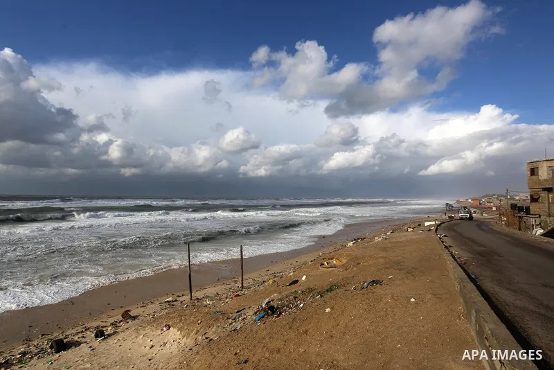 Palestians enjoy during a stormy day, at a beach in Deir El-Balah, in the center of the Gaza Strip, on February 17, 2021. The cloudy, stormy and very cold conditions are expected to continue on Thursday. Scattered torren...