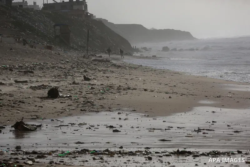 Palestians enjoy during a stormy day, at a beach in Deir El-Balah, in the center of the Gaza Strip, on February 17, 2021. The cloudy, stormy and very cold conditions are expected to continue on Thursday. Scattered torren...