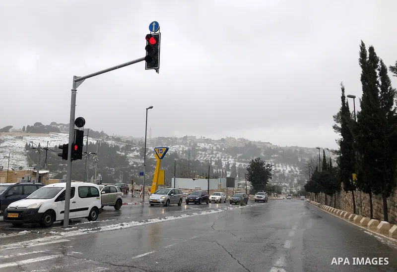 Roofs of Jerusalem's Old city are covered with snow during a snow storm, in the Dome of the Rock Mosque in Jerusalem's al-Aqsa mosque compound, on February 18, 2021. The bad weather and snow that hit Palestine yesterday...