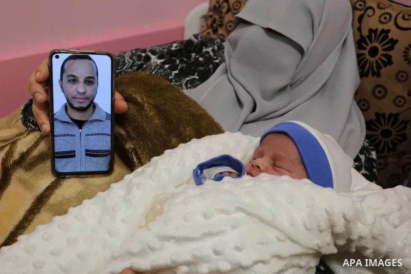 The wife of the Palestinian prisoner Mohammad al-Qudra, holds her newborn baby, from whom she conceived with sperm smuggled out of an Israeli prison, at Nasser Medical Complex in khan Younis in the southern of Gaza strip...