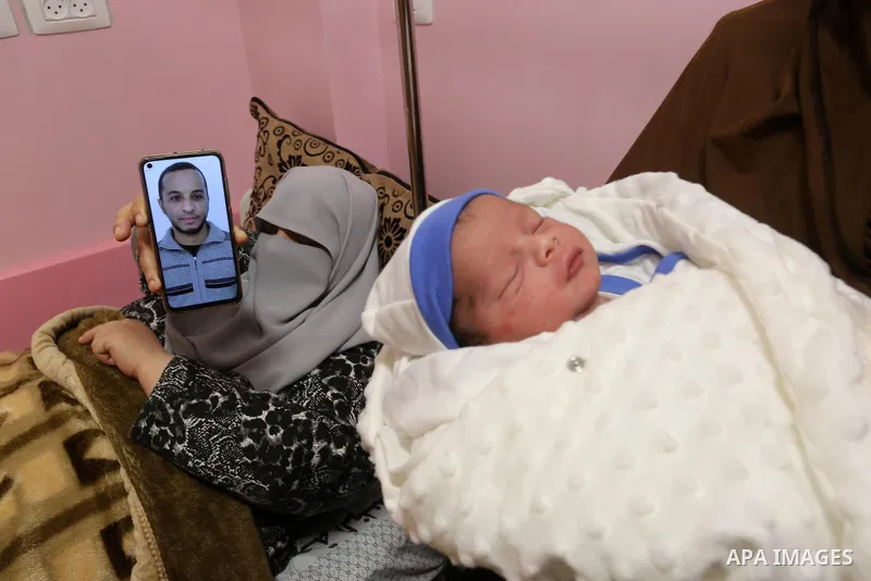 The wife of the Palestinian prisoner Mohammad al-Qudra displays her husband's picture, who is imprisoned in Israeli prisons, on the mobile phone, at Nasser Medical Complex in khan Younis in the southern of Gaza strip on...