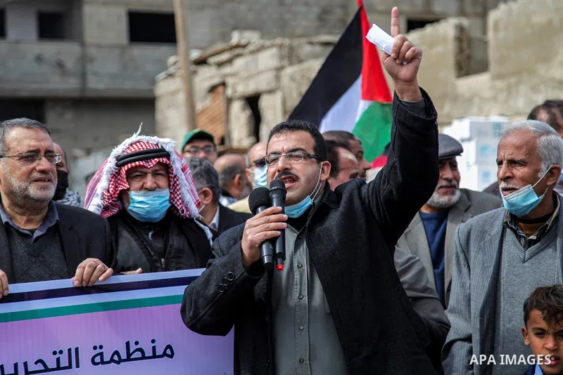 Palestinians take part in a protest against the reduction of the food basket provided by UNRWA, in front of the its aid distribution center, at Al-Shati refugee camp in Gaza City, on February 21, 2021. Palestinian refuge...
