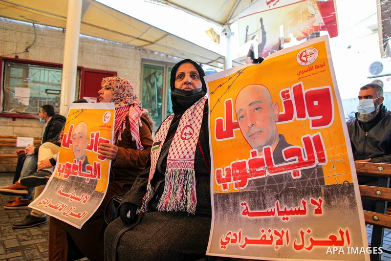 Palestinians take part in a protest to show solidarity with prisoners and the spread of the coronavirus disease (COVID-19) on Israeli Jails, in front of the headquarters of Red cross in Gaza city, on February 22, 2021. P...