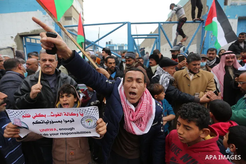 Palestinians take part in a protest against the reduction of the food basket provided by UNRWA, in front of the its aid distribution center, in Khan Yunis, in the southern Gaza Strip, on February 23, 2021. Palestinian re...