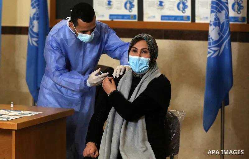 A Palestinian woman receives a dose of coronavirus disease (COVID-19) vaccine at a UN clinic in Gaza City, on February 24, 2021. Palestinians in Gaza began a limited COVID-19 vaccination programme on Monday after receivi...