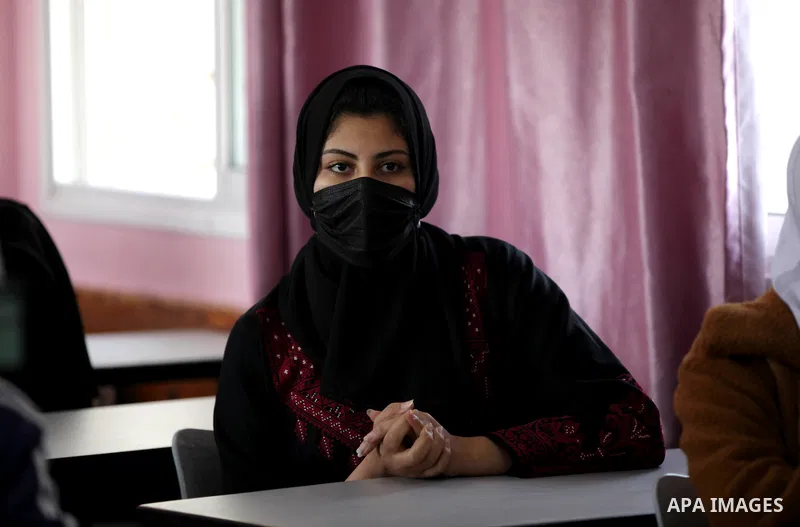 Palestinian students wearing protective face masks, sit in a classroom, in the morning of the first day of the second semester study, amid the coronavirus disease (COVID-19) outbreak, at their school, in Gaza city, on Fe...