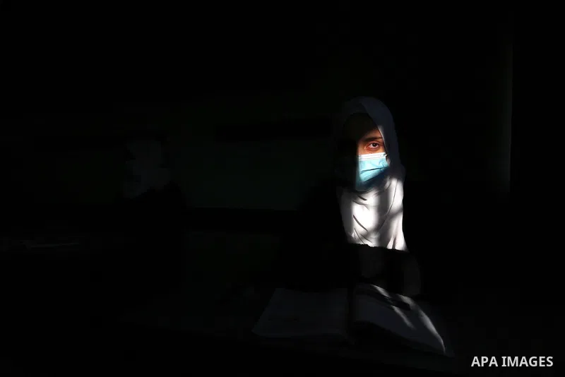Palestinian students wearing protective face masks, sit in a classroom, in the morning of the first day of the second semester study, amid the coronavirus disease (COVID-19) outbreak, at their school, in Dair Al Balah in...