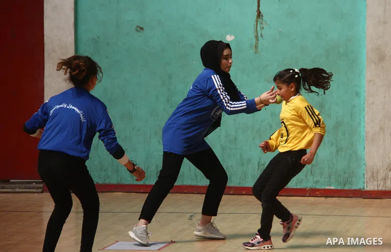 Palestinian female players, compete during the Palestine Junior Championship, in Gaza city on February 27, 2021. Baseball is a bat-and-ball game played between two teams of nine players each, who take turns batting and f...