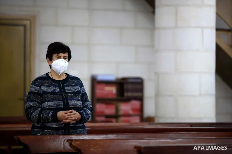 Christian worshippers pray inside Church, amid the coronavirus lockdown in the town of Zababdeh, south of Jenin, in the West Bank on February 28, 2021. Prime Minister Mohammad Shtayyeh announced a new set of restrictions...