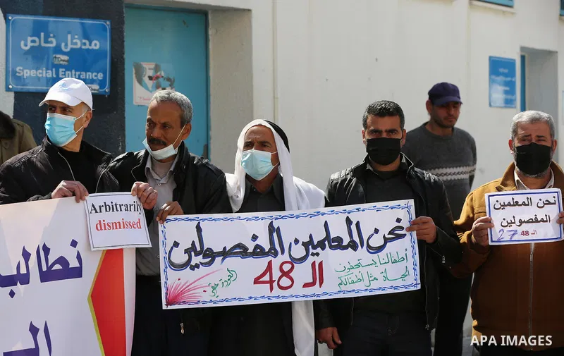 Palestinians take part in a protest against the reduction of the food basket provided by UNRWA, in front of the its headquarter, in Gaza city, on March 2, 2021. UNRWA said that this year, the Agency will support approxim...