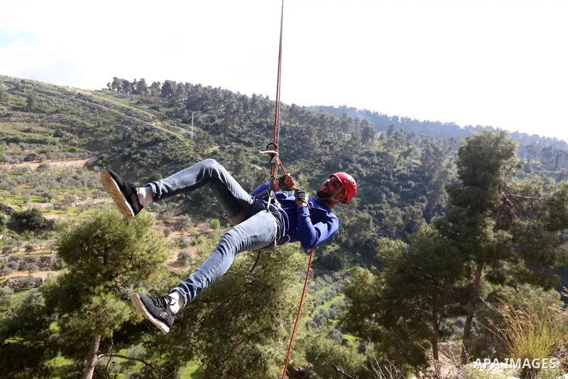 Team Rahal Palestine climb slopes on Wadi al-Qaf west of Hebron, on March 5, 2021. Wadi al-Qaf is a protected area of 4,600 dunums of the state’s land. The cultivated area is about 2,800 dunums, according to the estimate...