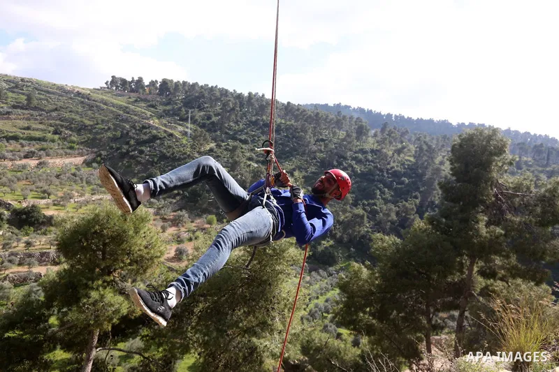 Team Rahal Palestine climb slopes on Wadi al-Qaf west of Hebron, on March 5, 2021. Wadi al-Qaf is a protected area of 4,600 dunums of the state’s land. The cultivated area is about 2,800 dunums, according to the estimate...