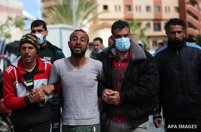 Palestinian relatives of three fishermen cry at Nasser Hospital in Khan Yunis, southern Gaza Strip, on March 7, 2021. Three Palestinian fishermen were killed in an explosion of unknown cause off the coast of the Gaza Str...