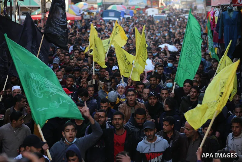 Palestinian mourners carry the body of the three Palestinian fishermen, who were killed when their boat exploded off Gaza's coast in the Mediterranean Sea, during their funeral in Khan Yunis in the southern Gaza Strip on...