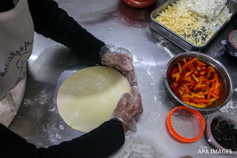 Palestinian women prepare pastries and sweets in their shop on the International Women's Day, in Dair Al Balah in the central of Gaza Strip, on March 7, 2021. International Women's Day (IWD) is celebrated on 8 March arou...