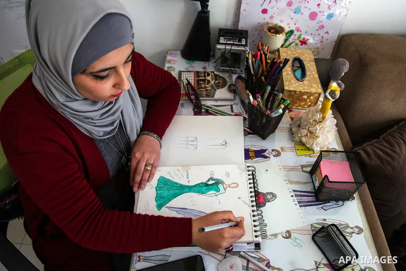 A Palestinian tailor Amina Hamo, 28, sews at her workshop on the International Women's Day, in Gaza city on March 8, 2021. In light of difficult economic and living conditions for Gazans. Throughout the decades that Pale...