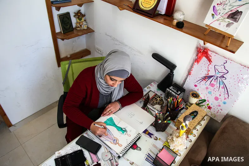 A Palestinian tailor Amina Hamo, 28, sews at her workshop on the International Women's Day, in Gaza city on March 8, 2021. In light of difficult economic and living conditions for Gazans. Throughout the decades that Pale...