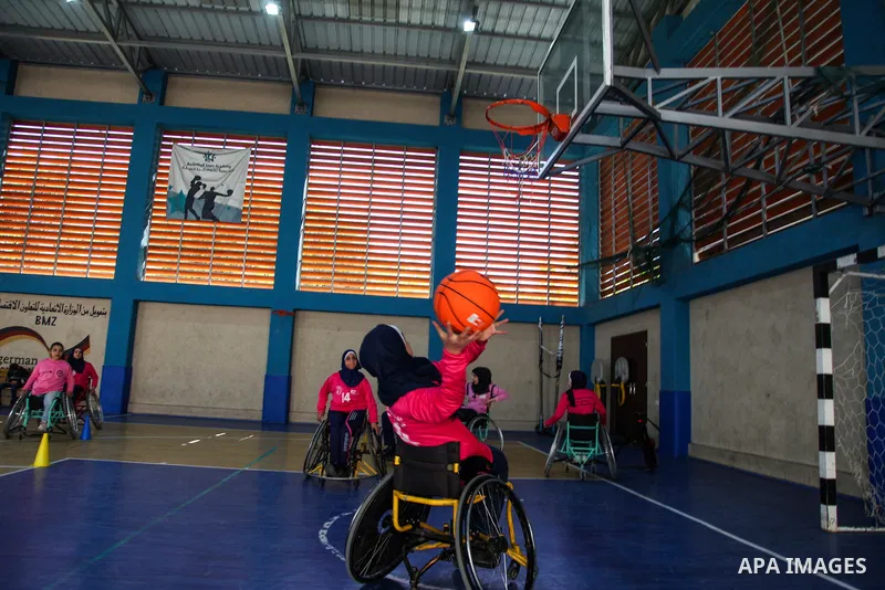 Palestinians women of special needs take part in a basketball training in a gymnasium, on the International Women's Day, on March 8, 2021. International Women's Day (IWD) is celebrated on 8 March around the world. It is...
