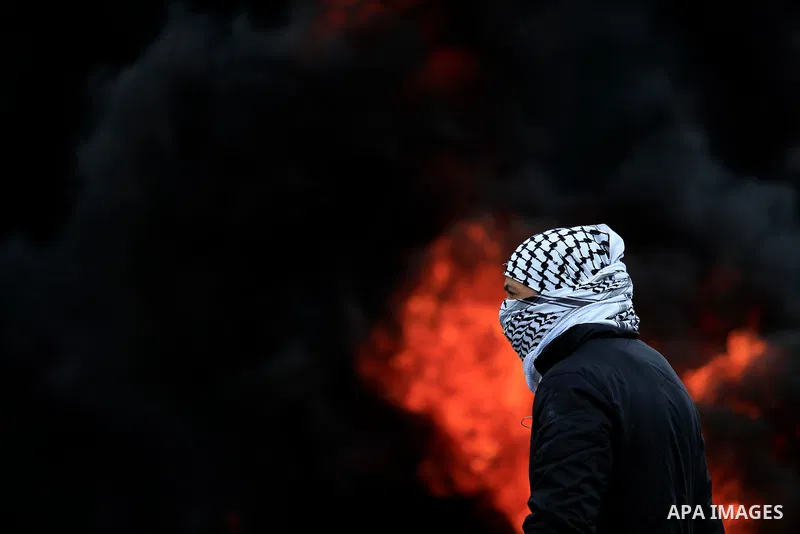 Palestinian protesters burn tires during clashes with Israel forces following a weekly demonstration against the expropriation of Palestinian land by Israel in the village of Kfar Qaddum, near the West Bank city of Nablu...