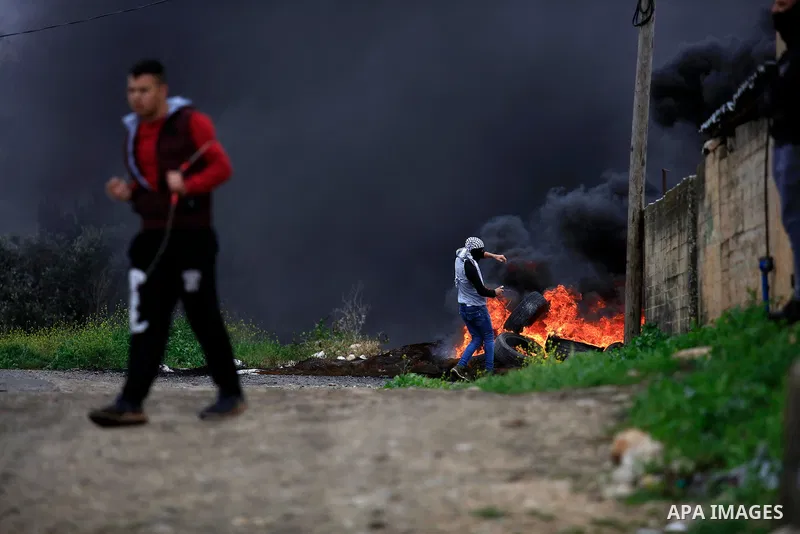Palestinian protesters burn tires during clashes with Israel forces following a weekly demonstration against the expropriation of Palestinian land by Israel in the village of Kfar Qaddum, near the West Bank city of Nablu...