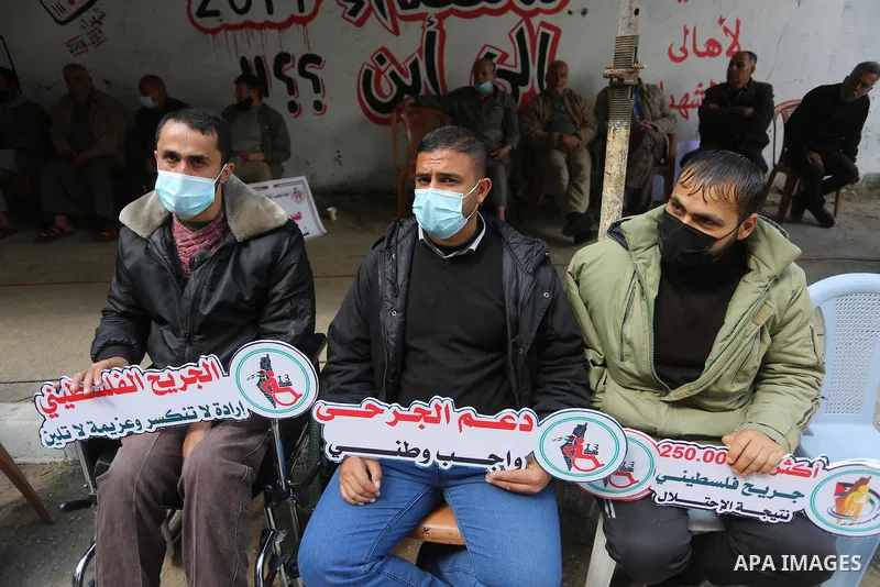 Palestinians take part in a protest take part in a protest on the Palestinian Wounded's Day, in Gaza city, on March 13, 2021. Al-Mezan Center for Human Rights said that more than (250,000) Palestinians were injured by th...