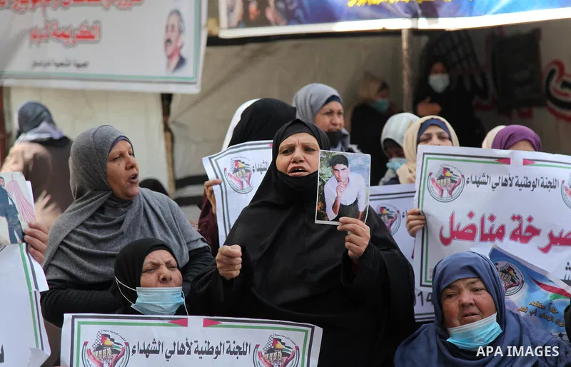 Families of Palestinian martyrs and wounded, take part in a protest against the Palestinian Authority's decision to cut their salaries for seven years, in Gaza city, on Msrch 16, 2021. In January 2019, the PA cut the sal...