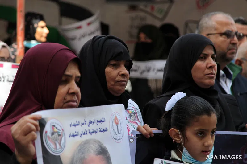 Families of Palestinian martyrs and wounded, take part in a protest against the Palestinian Authority's decision to cut their salaries for seven years, in Gaza city, on Msrch 16, 2021. In January 2019, the PA cut the sal...