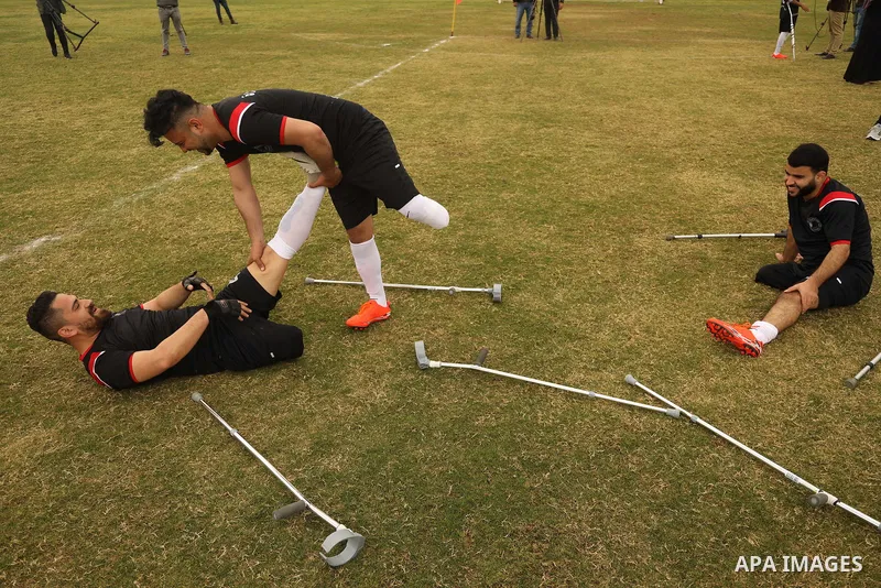 Palestinian amputees using crutches play a football match during the final match tournament for amputees, at Palestine Stadium in Gaza city, on March 18, 2021. Al-Mezan Center for Human Rights said that more than (250,00...