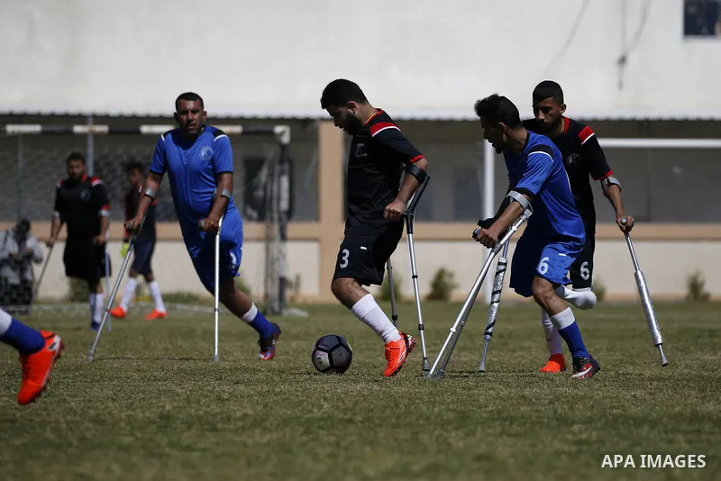 Palestinian amputees using crutches play a football match during the final match tournament for amputees, at Palestine Stadium in Gaza city, on March 18, 2021. Al-Mezan Center for Human Rights said that more than (250,00...