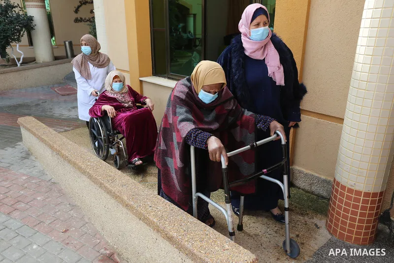 Palestinian elderly take part during a celebration on the occasion of Mother's Day, at el-Wafa elderly nursing home in Gaza city, on March 21, 2021. Mother's Day is a celebration honoring the mother of the family, as wel...