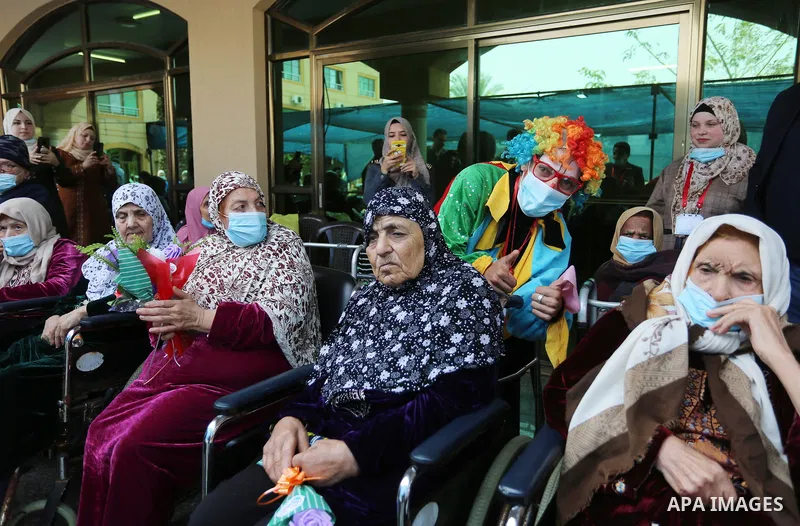 Palestinian elderly take part during a celebration on the occasion of Mother's Day, at el-Wafa elderly nursing home in Gaza city, on March 21, 2021. Mother's Day is a celebration honoring the mother of the family, as wel...