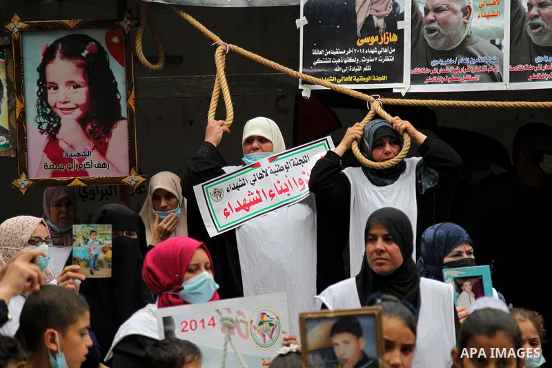 Families of Palestinian martyrs and wounded, take part in a protest tent against the Palestinian Authority's decision to cut their salaries for seven years, in Gaza city, on March 23, 2021. "The leaders agreed on the sol...