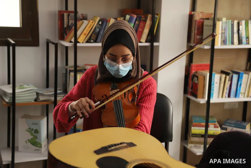 Palestinian students attend a music class at the "House of Music" center in Gaza City, on March 24, 2021. The "house of Music" is a training center established two months ago. It has currently about 30 students. They pra...