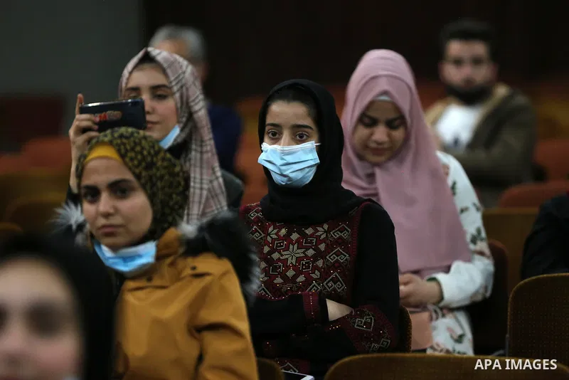 Palestinians wear protective face masks, amid the coronavirus disease (COVID-19), attend the operetta entitled "Gharib ya Bladi" on the anniversary of the Battle of Dignity and International Theater Day in Gaza City on M...