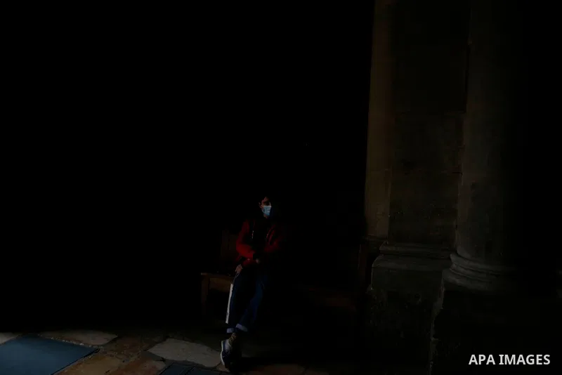 Christian worshippers pray inside Church of Holy Sepulcher, amid the coronavirus lockdown, in Jerusalem's Old City, on March 25, 2021. The Palestinian government decided to re-apply the partial closure in the West Bank,...