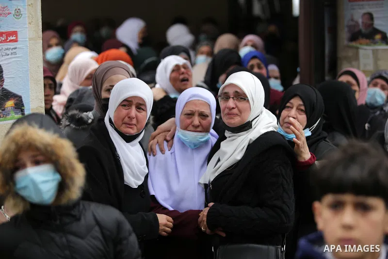 Palestinians attend the funeral of a founding committee member of the Palestinian Campaign for the Academic and Cultural Boycott of Israel (PACBI) and a co-founder of the Boycott, Divestment and Sanctions (BDS) movement,...