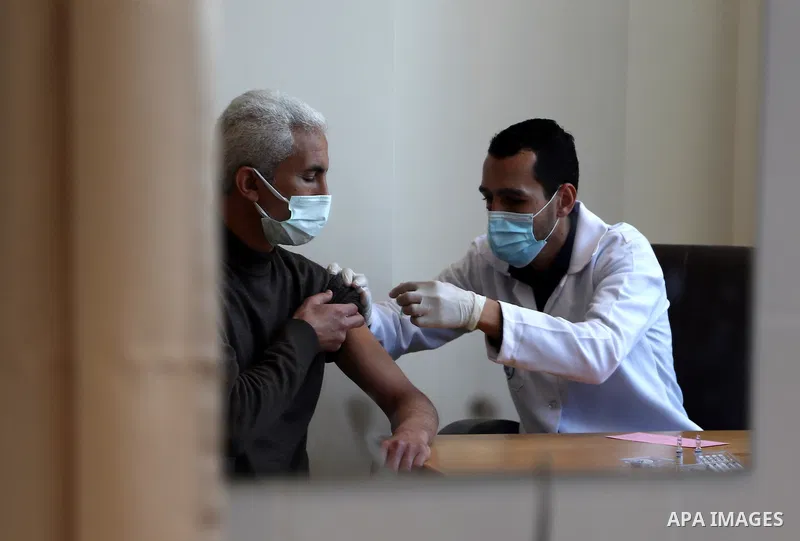 Palestinians receive the dose of the coronavirus disease (COVID-19) vaccine at the UNRWA clininc, in Gaza city on March 27, 2021. The Palestinian authorities have begun administering vaccines supplied under the internati...