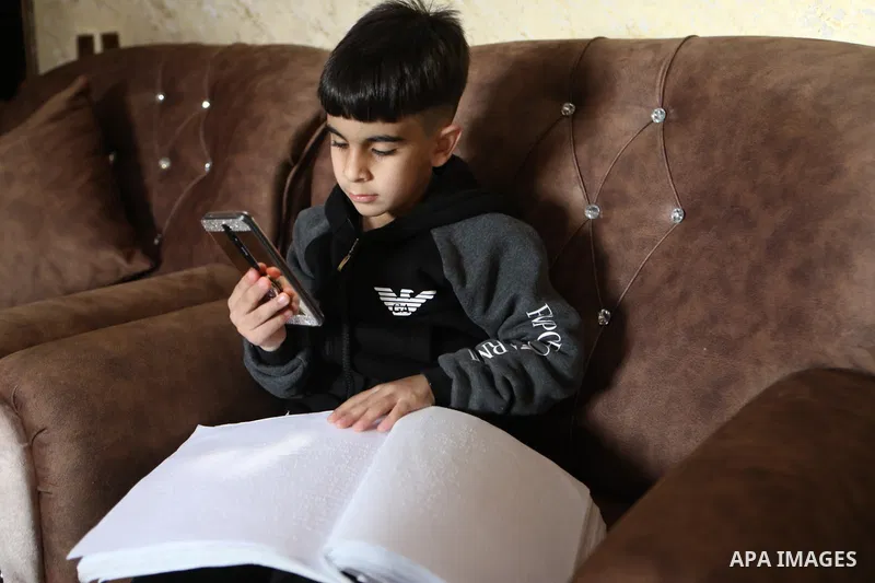 The two blind Palestinian children, Yusef and Retaj Abu Dawood, receive electronic education in Braille, at their home in the West Bank City of Hebron on March 28, 2021. The COVID-19 crisis continues to rattle K-12 educa...