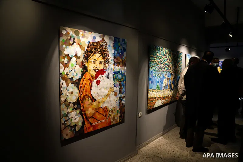 Palestinians attend an exhibition of the artist Mohammad Alkrunz, entitled "camp countryside", in Gaza city, on March 30, 2021. Photo by Mohammed Salem