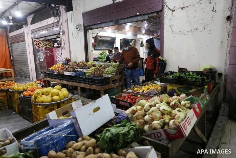 Palestinians shop at a market in Deir Al-Balah in the center of the Gaza Strip, on April 1, 2021. The Ministry of Interior and National Security has taken a set of measures that will start to be implemented tomorrow, Fri...