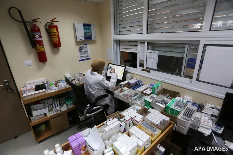 UNRWA employees wear face masks as the provide services, amid the spread of the Coronavirus COVID-19, in a UN clinic in Deir El-Balah, in the center of the Gaza Strip, on April 3, 2021. President Mahmoud Abbas today issu...