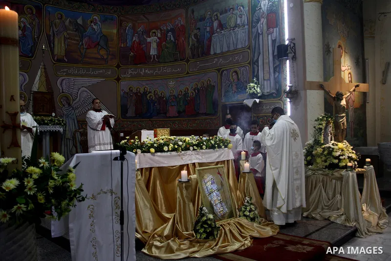 Palestinian Christians attend an Easter vigil mass, amid the coronavirus disease (COVID-19) outbreak at a church of Deir Latin, in Gaza City, on April 4, 2021. Easter Vigil, also called the Paschal Vigil or the Great Vig...