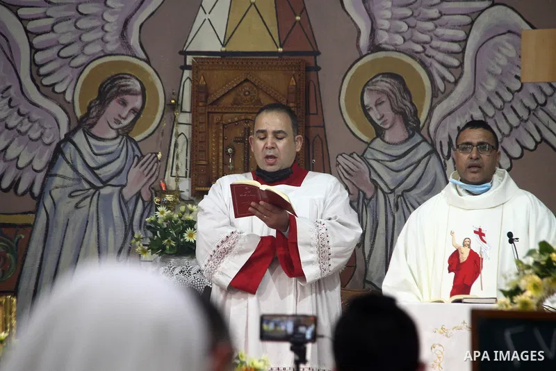 Palestinian Christians attend an Easter vigil mass, amid the coronavirus disease (COVID-19) outbreak at a church of Deir Latin, in Gaza City, on April 4, 2021. Easter Vigil, also called the Paschal Vigil or the Great Vig...