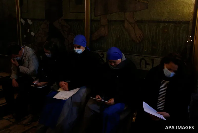 Priests participate in the Easter Sunday Mass led by the Latin Patriarch at the Church of the Holy Sepulchre where Jesus Christ is believed to be buried, in the Old City of Jerusalem, on 4 April 2021. Easter Vigil, also...