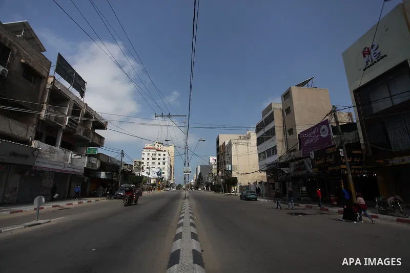 Paestinians walk at a deserted street is pictured during a lockdown following the outbreak of the coronavirus disease (COVID-19), in Gaza city, on April 8, 2021. Hospitals in the Palestinian Territories of the West Bank...