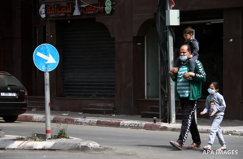 Paestinians walk at a deserted street is pictured during a lockdown following the outbreak of the coronavirus disease (COVID-19), in Gaza city, on April 8, 2021. Hospitals in the Palestinian Territories of the West Bank...